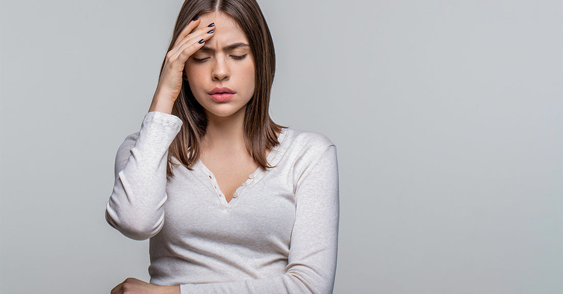 Psychologicial Impact of Incontinence - Woman in White t-shirt with a stressed demeanor