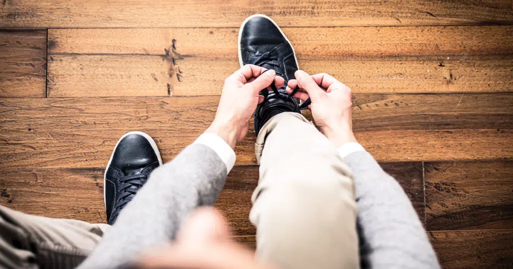 Person tying their shoe - Strategies for Incontinence Management